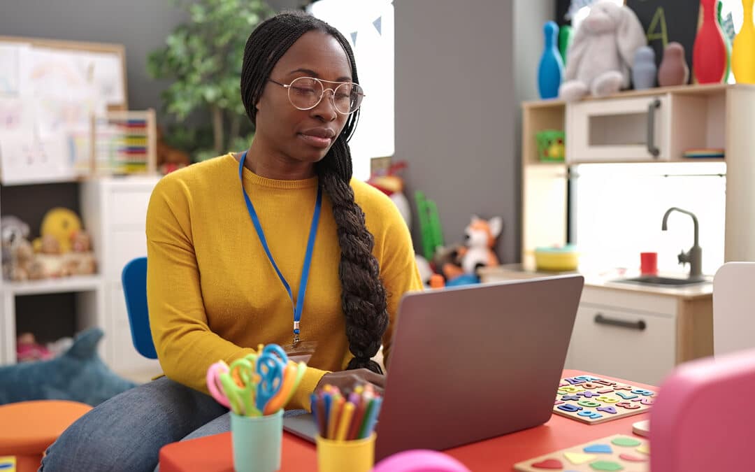 Woman Using A Laptop In An Elementary School