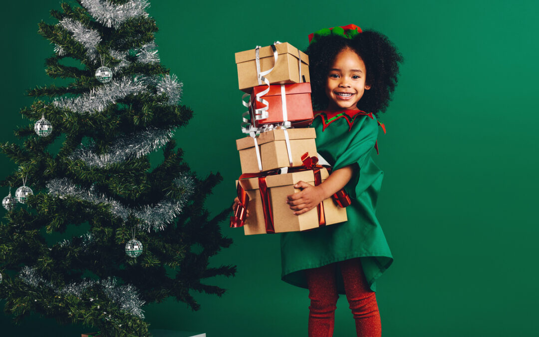 Girl Holding A Present Next To A Tree